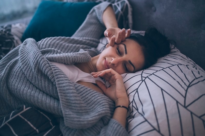 The Best Time to Take Supplements for Sleep Woman Waking Up in Bed After a Night of Quality Sleep | Vitacost.com/Blog