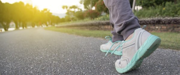 Person Doing Walking Workout in Park Early in the Morning on Asphalt Trail | Vitacost.com/blog