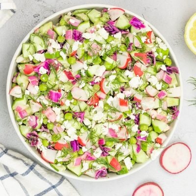 An Overhead Shot of a Large Bowl of Cucumber Dill Salad With Radishes, Dill, Cabbage and More | Vitacost Blog