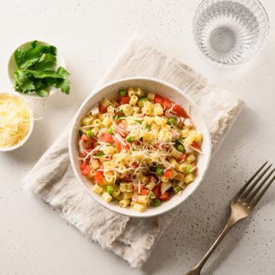 Ditalini Pasta Salad with Tomatoes, Diced Chicken & Peas in White Bowl on White Modern Table | Vitacost.com/Blog