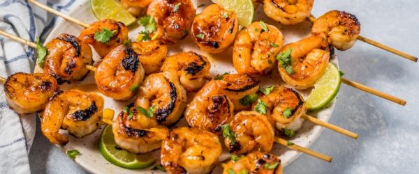 Sweet & Spicy Grilled Shrimp Recipe on Skewers on Serving Platter with Lime Wedges & Cilantro | Vitacost.com/Blog