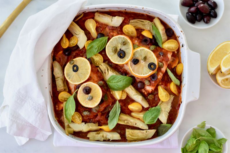 Tomato & Artichoke Baked Cod Fillets in White Baking Dish with Basil, Olives and Lemon Slices | Vitacost.com/blog