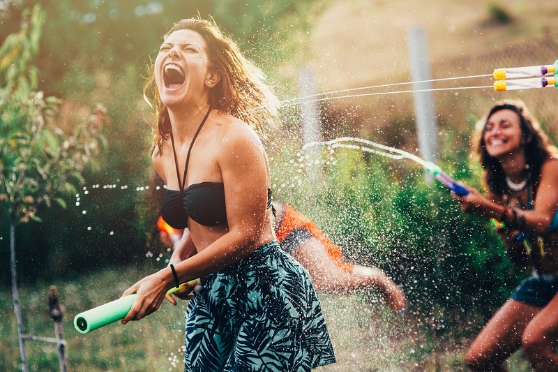 Adults Playing Outside with Water Guns | Vitacost.com/Blog