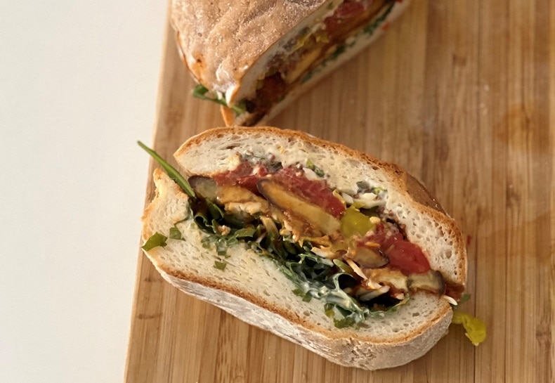Homemade Vegan Roasted Eggplant Muffuletta Sandwich on Cutting Board | Vitacost.com/Blog