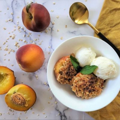 Baked Peaches With Cinnamon-Oat Crumble in White Bowl with Golden Spoon | Vitacost.com/Blog