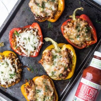Cheeseburger Stuffed Peppers with Cheese on Baking Sheet Next to Primal Kitchen Ketchup & Mustard | Vitacost.com/blog