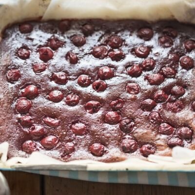 Chocolate Brownies With Cherries on Top in Baking Pan on Blue & White Checkered Dish Towel | Vitacost.com/Blog