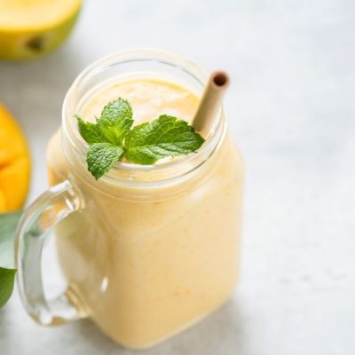 Dairy-Free Indian Mango Lassi in Mason Jar Glass with Mint Leaf Garnish | Vitacost.com/blog