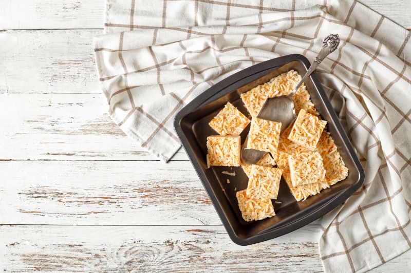No-Bake Coconut Bars in Pan on White-Washed Wooden Table | Vitacost.com/blog