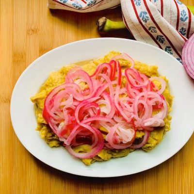 Dominican Mangú: Mashed Plantains With Pickled Red Onions Plated on a Bamboo Surface