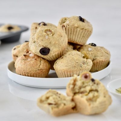 Homemade Rosemary-Olive Savory Muffins Stacked on Plate