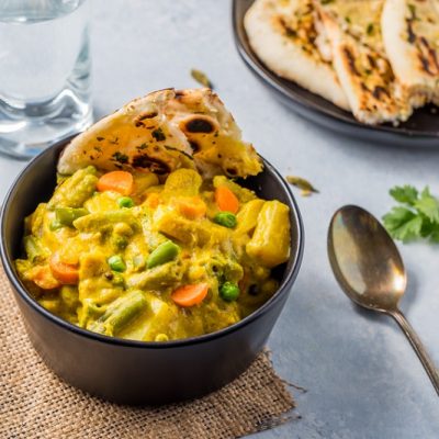 Homemade Vegetarian Korma in Bowl with Fresh Naan