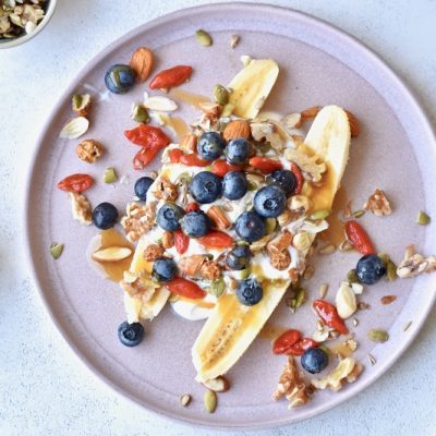 Homemade Breakfast Banana Split Topped with Greek Yogurt, Nuts, Seeds and Berries on Plate | Vitacost Blog