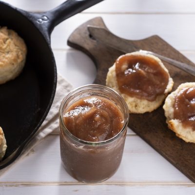 Slow Cooker Apple Butter in Jar and Spread on Biscuits