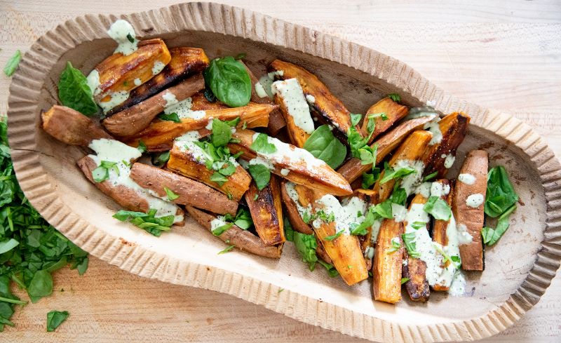 Sweet Potato Wedges With Herb Cream Sauce in Compostable Paper Bowl