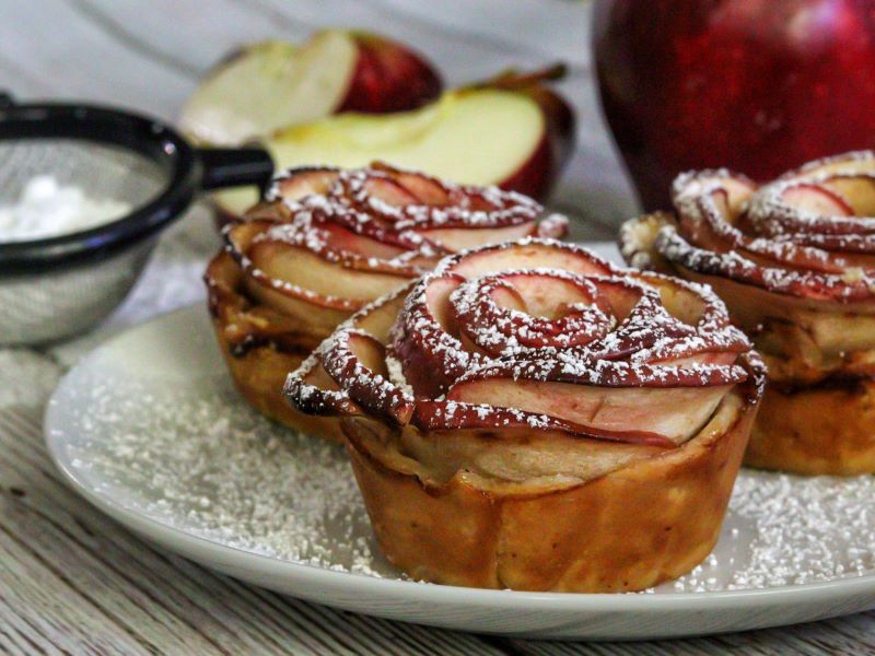 Cinnamon Apple Roses Dusted with Powdered Sugar and Placed on Serving Plate