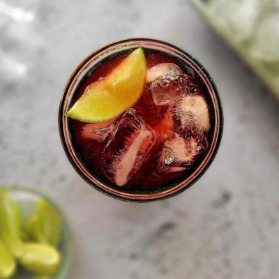 Tart Cherry Creatine Booster Beverage in Glass with Lime Wedge