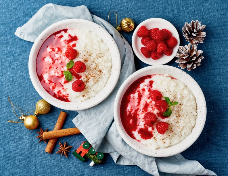 Bowls of Oatmeal and Berries on Blue Cloth With Holiday Accents to Represent Foods That Reduce Stress