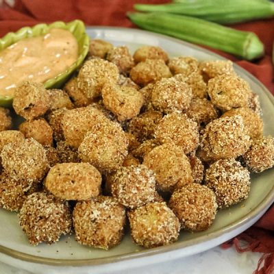 A Large Plate is Covered in Air Fryer Okra and a Small Sauce Dish With Homemade Remoulade.