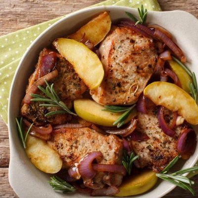 Skillet Pork Chops With Apples & Onion on Wooden Table