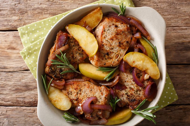 Skillet Pork Chops With Apples & Onion on Wooden Table