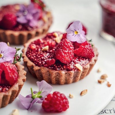 Mini Peanut Butter & Raspberry Jam Tarts on White Plate