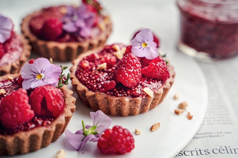 Mini Peanut Butter & Raspberry Jam Tarts on White Plate