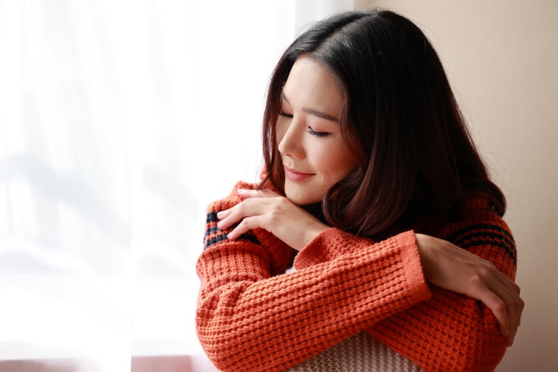 Smiling Relaxed Woman With Clear Complexion Thanks to Practicing Psychodermatology