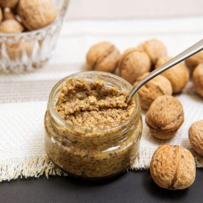 Roasted Walnut Butter in Small Glass Jar on Cloth Napkin