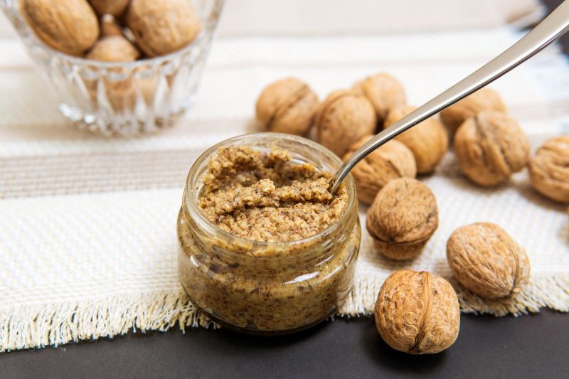 Roasted Walnut Butter in Small Glass Jar on Cloth Napkin