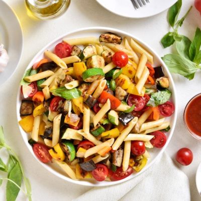 Roasted Ratatouille Pasta Salad in Serving Bowl on Counter Full of Fresh Ingredients