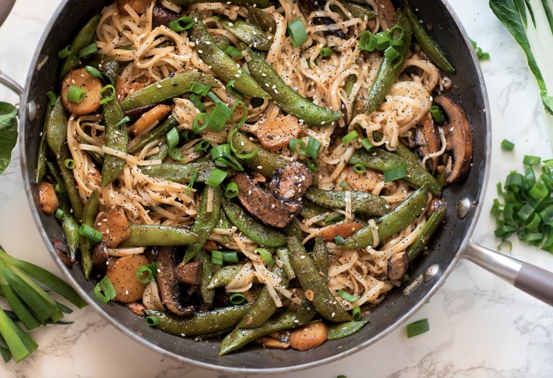Rice Noodle Bowl With Snap Peas, Mushroom & Water Chestnuts in Skillet