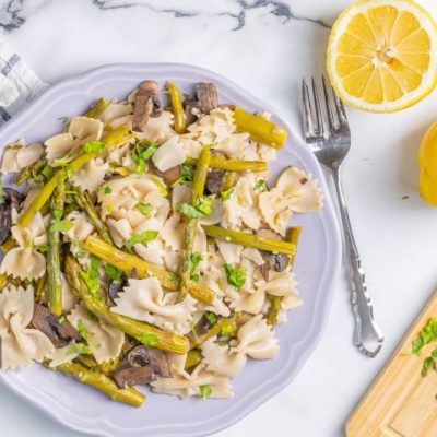 Lemon Asparagus Pasta with Mushrooms on Plate Set on Marble Counter