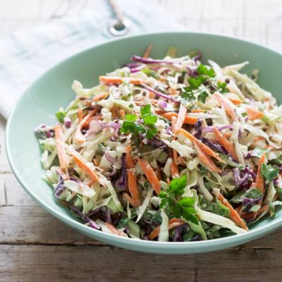 Keto Coleslaw in Green Bowl on White Wooden Tabletop