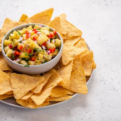 Pineapple Salsa in Bowl Surrounded by Chips