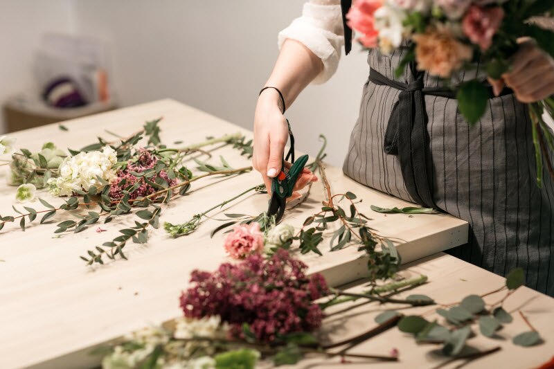 Woman Cutting Fresh Flowers in Flower Arranging Activity to Support Mental Health