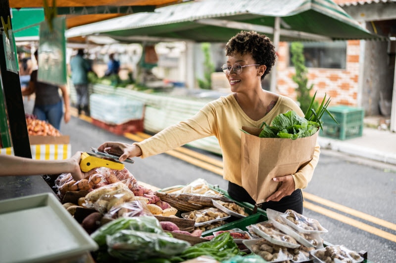 Smiling, Relaxed Woman Enjoying Benefits of Shopping at Farmers' Markets