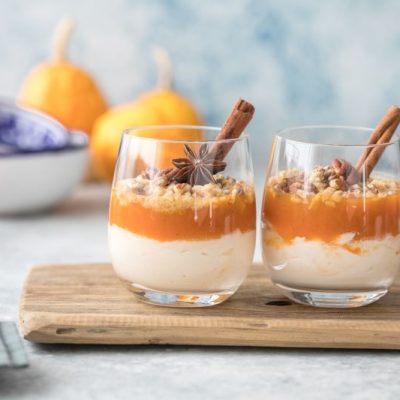 Two Pumpkin Pie Parfaits in Two Tumbler Glasses with Star Anise & Cinnamon Sticks