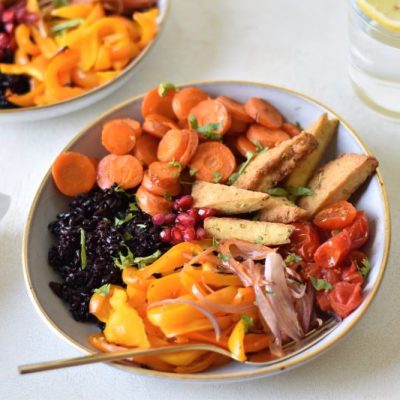 Bowl of Sheet Pan Roasted Veggies & Tofu on Table top Next to Another Bowl of Same Meal, Bright with Carrots, Orange Peppers and Cherry Tomatoes