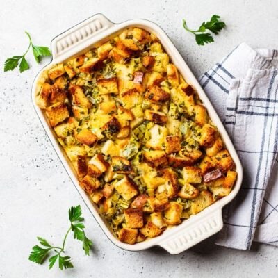 Savory Gluten-Free Stuffing in Baking Dish on Counter Sprinkled With Parsley