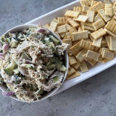 Leftover Turkey Salad in a Dip Bowl Next to an Assortment of Crackers