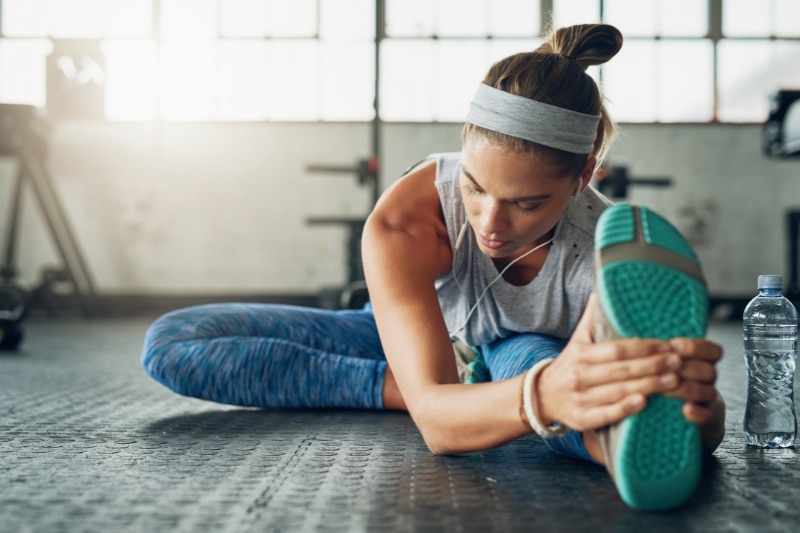 Woman Stretching With Pulled Muscle 
