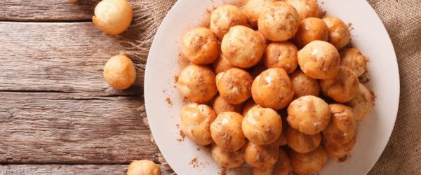 Hanukkah Doughnut Holes (Gluten-Free) Drizzled with Honey on Round White Plate