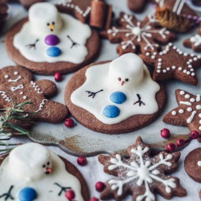 Gingerbread Cookies and Other Festive-Shaped Cookies Lay Together With Melted Snowman Cookies.