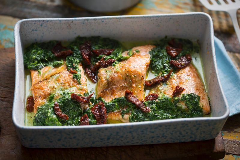 Baked Salmon with Sun-Dried Tomatoes & Kale in Baking Pan on Table