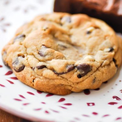 Vegan Chocolate Chip Cookie Recipe: Wholesome, Oversized Cookie on Red & White Plate