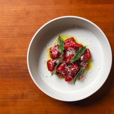 Homemade Gnocchi Made With Beets, Brown Butter & Sage in Round White Bowl
