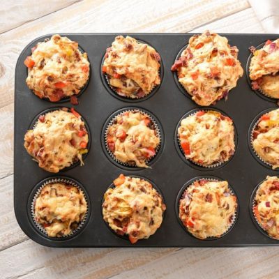 12 Pizza Muffins Rising out of Top Muffin Pan on Wooden Table Top