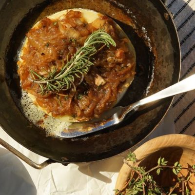 Brie Appetizer: Brie and Caramelized Onions in Baking Pan on Sun-Drenched Table