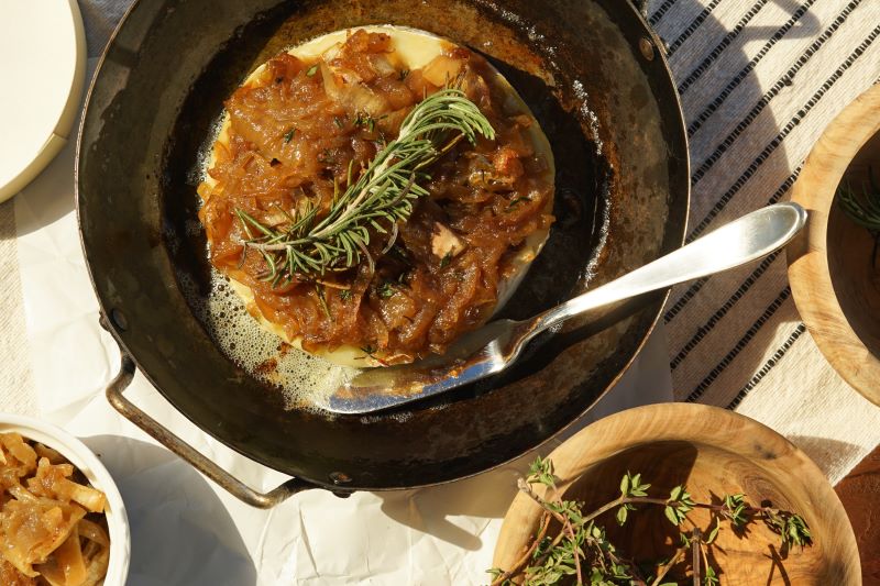 Brie Appetizer: Brie and Caramelized Onions in Baking Pan on Sun-Drenched Table